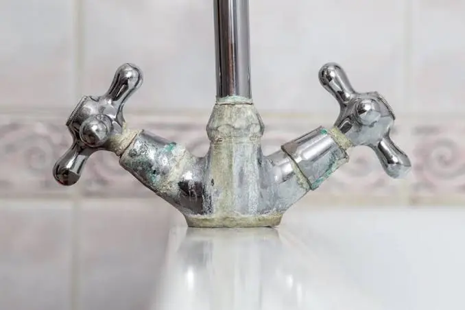 hard water in Corona CA causing white calcium buildup on bathroom faucet and sink fixtures