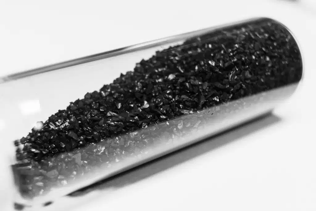A close-up photo of activated carbon granules or carbon filter media